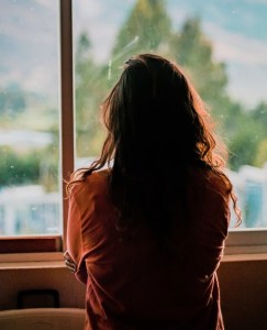 woman wearing brown shirt inside room